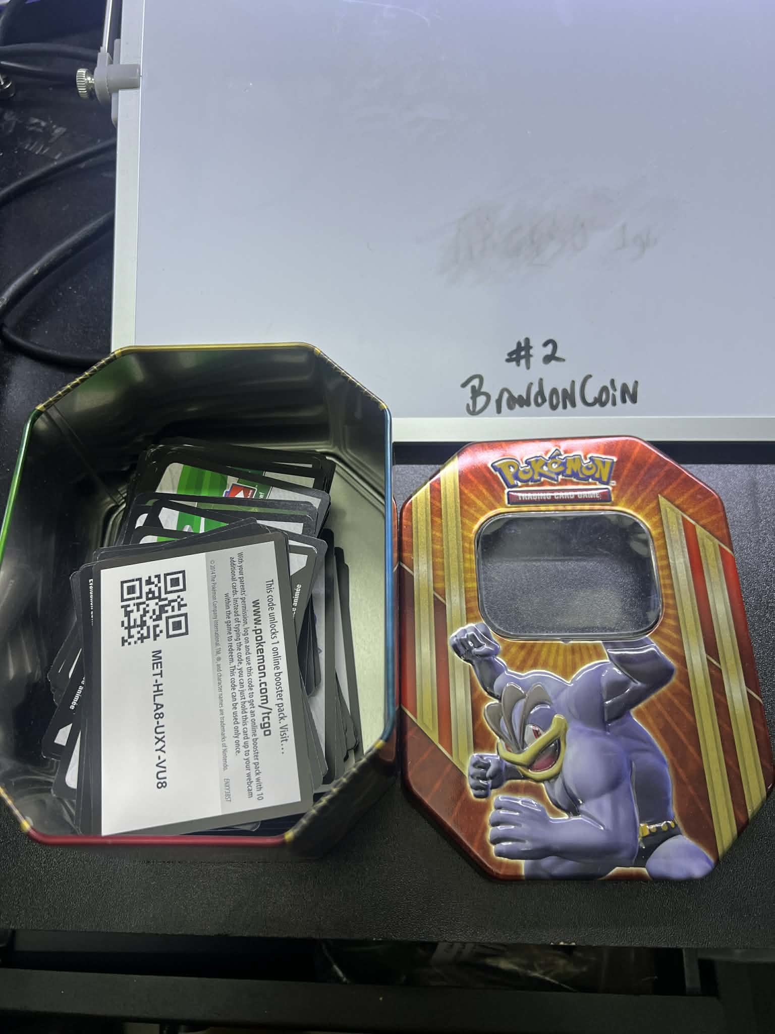 Pokemin tin with Game code cards machamp top